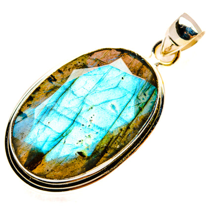 Oval labradorite pendant set in silver bezel with round bail, blue-green flash