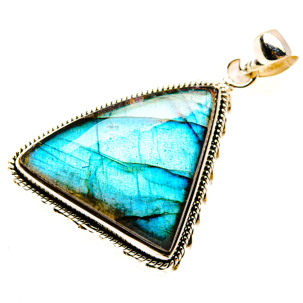 Triangular labradorite pendant with blue facet cabochon, sterling silver frame, and bail.