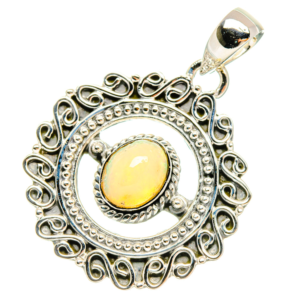 Sterling silver oval opal pendant with decorative scrolling bezel and bright yellow stone