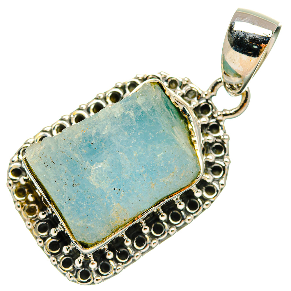 Rough aquamarine rectangle pendant with decorative halo border and silver bail