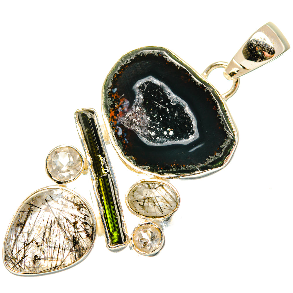 Black geode slice pendant with silver setting and druzy quartz; small clear stones detail.