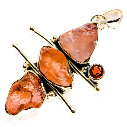 Sterling silver pendant with rough rose quartz and small garnet red accent stone