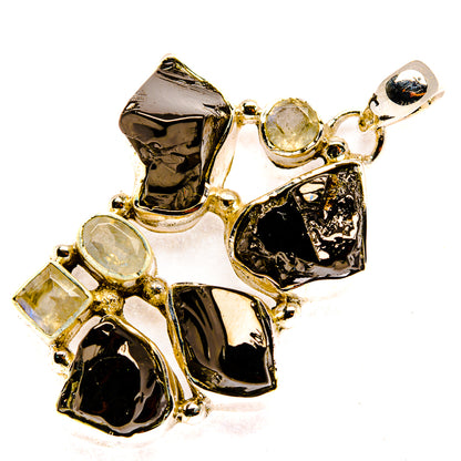 Rough gemstone pendant in polished silver with black stones and moonstone accents
