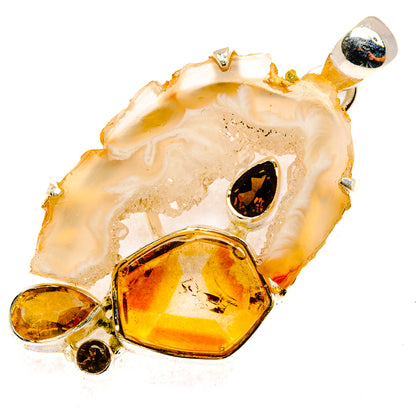 Geode slice pendant with faceted amber gems, dark stones, and silver prong settings