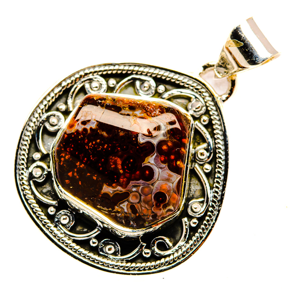Mexican fire agate pendant with decorative sterling silver border and faceted amber stone