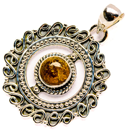 Round citrine pendant with ornate silver filigree and hanging bail