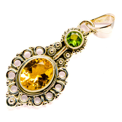 Round citrine and peridot pendant with ornate silver filigree and hook bail