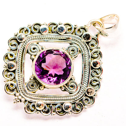 Sterling silver amethyst pendant with faceted purple stone, filigree border, top bail