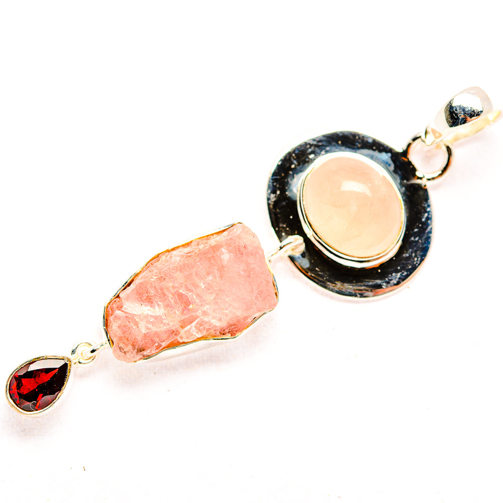 Sterling silver pendant with round peach rose quartz in black setting, rough pink stone, garnet