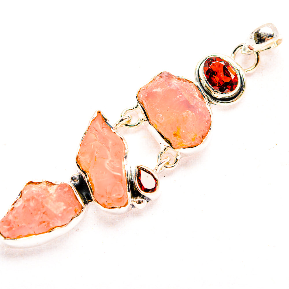 Rough rose quartz cluster pendant with round red garnet accents in 925 sterling silver