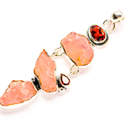 Rough rose quartz cluster pendant with round red garnet accents in 925 sterling silver