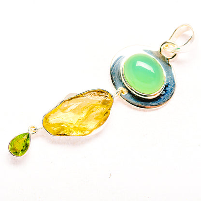 Sterling silver pendant with oval green cabochon, rough yellow stone, and small green charm
