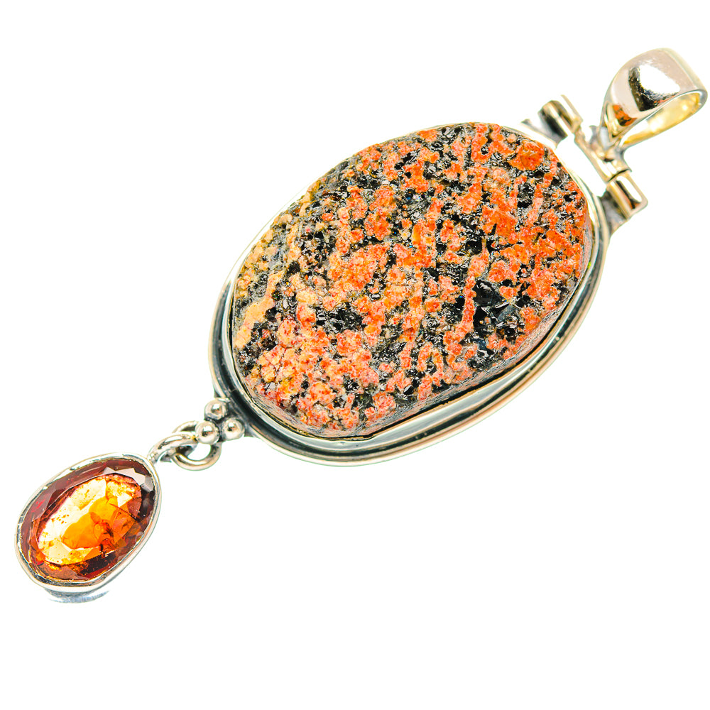 Oval orange-and-black stone pendant with sterling silver bail and dangling orange gem
