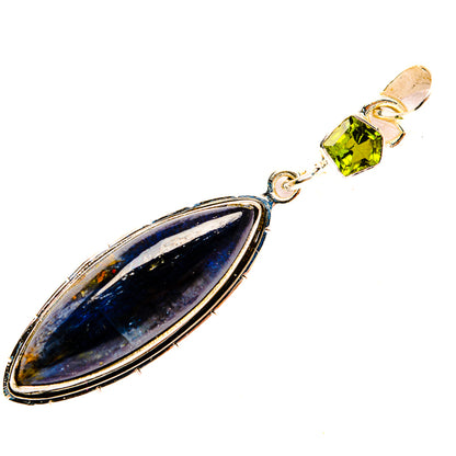 Sterling silver pendant with dark blue oval gemstone and small green peridot accent
