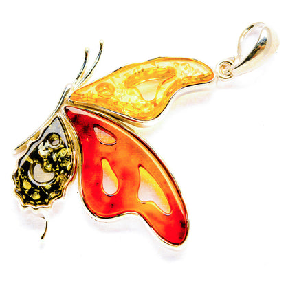 Butterfly pendant with red and honey amber wings in sterling silver setting
