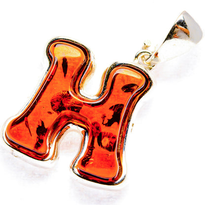 Baltic amber letter H pendant with orange amber cabochon and silver bail, 925 sterling.