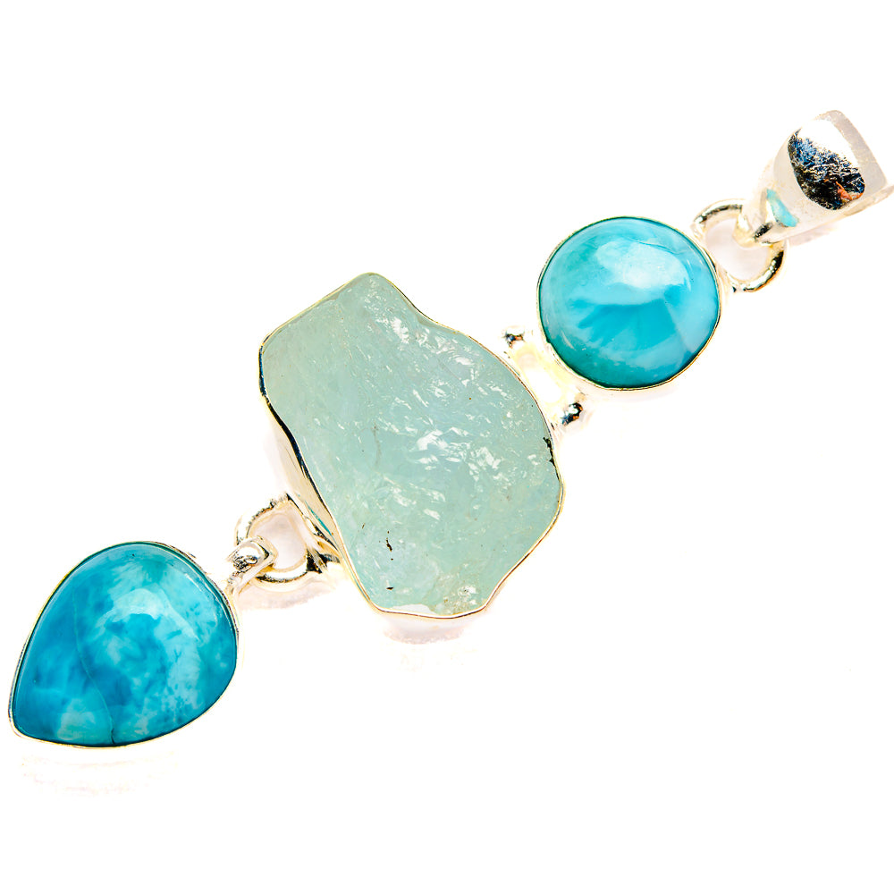 Rough aquamarine pendant with three silver settings and round blue stones