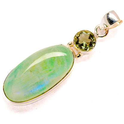 Oval green gemstone pendant with round green stone accents, silver-tone setting