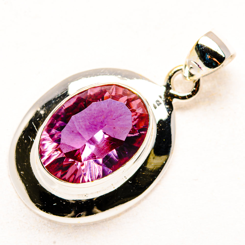 Sterling silver pendant with oval color-change gemstone in rosy purple bezel setting