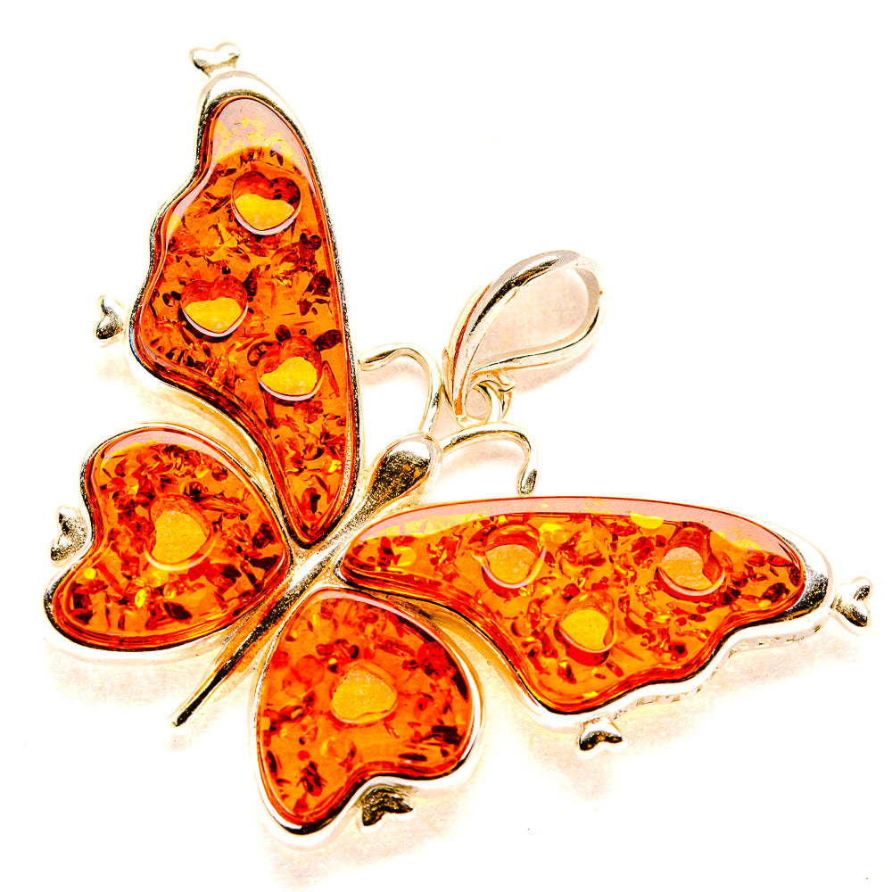Orange amber butterfly pendant with 925 sterling silver wings and cutout details