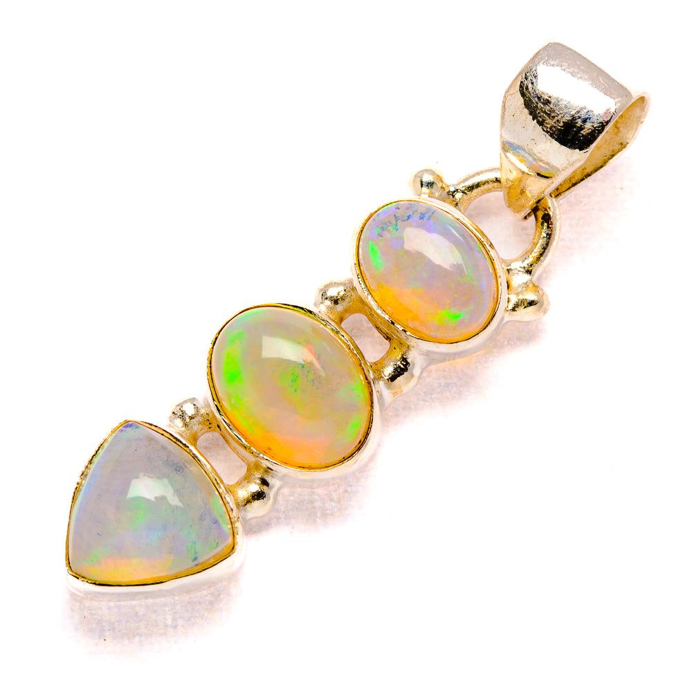 Opal pendant with three gold-tone bezel stones, oval and heart shapes, bail loop