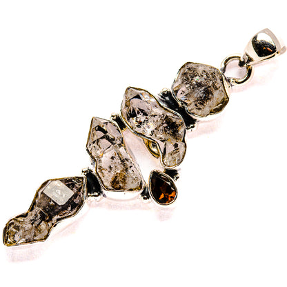 Sterling silver pendant with faceted smoky clear and dark red stones