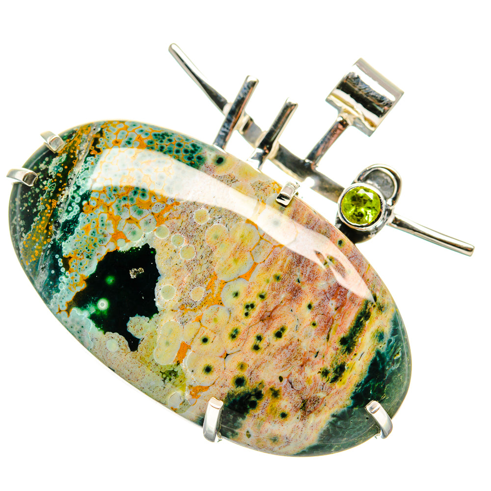 Oval ocean jasper pendant with round green peridot bezel in sterling silver