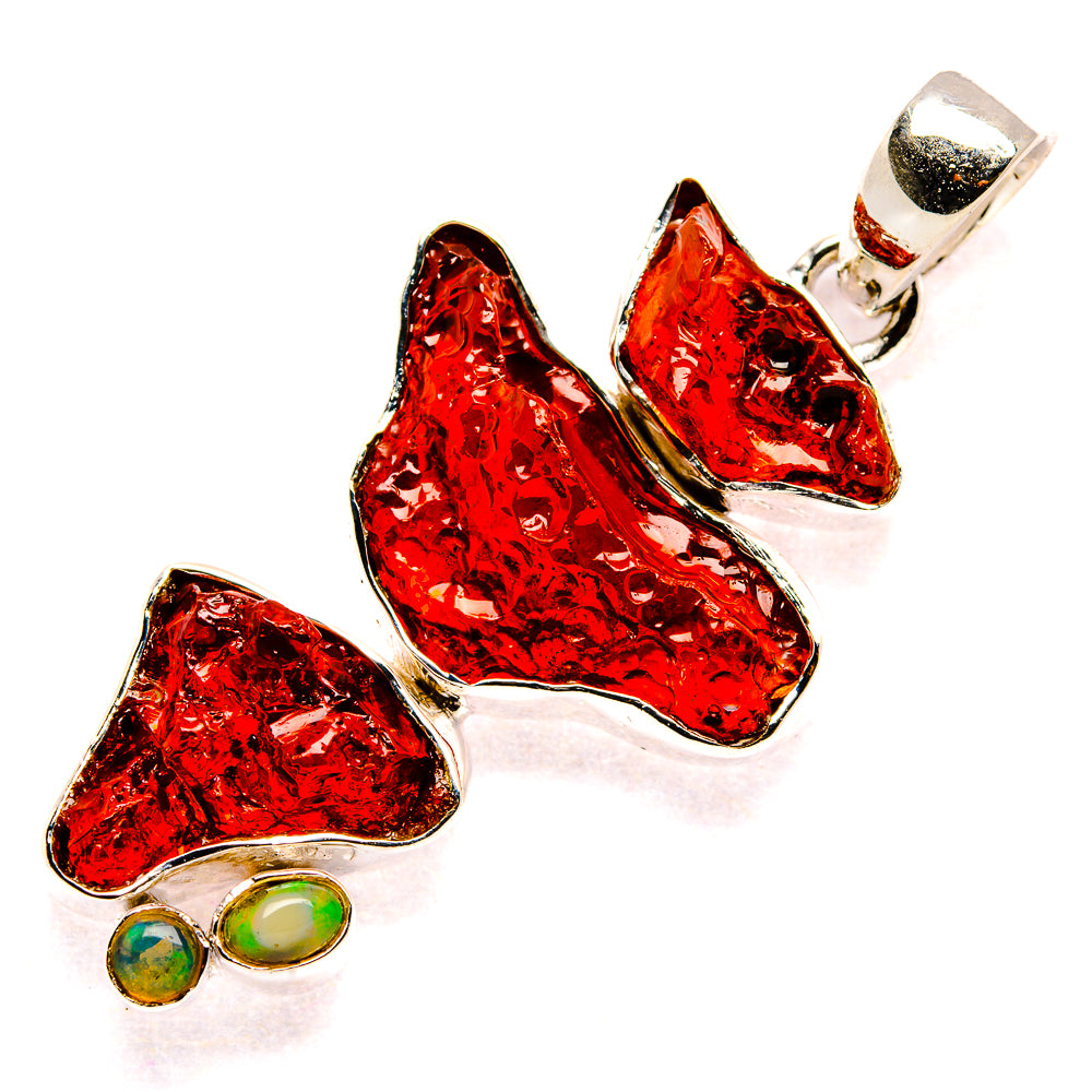 Rough red garnet pendant with silver bezel setting and two green opal cabochons