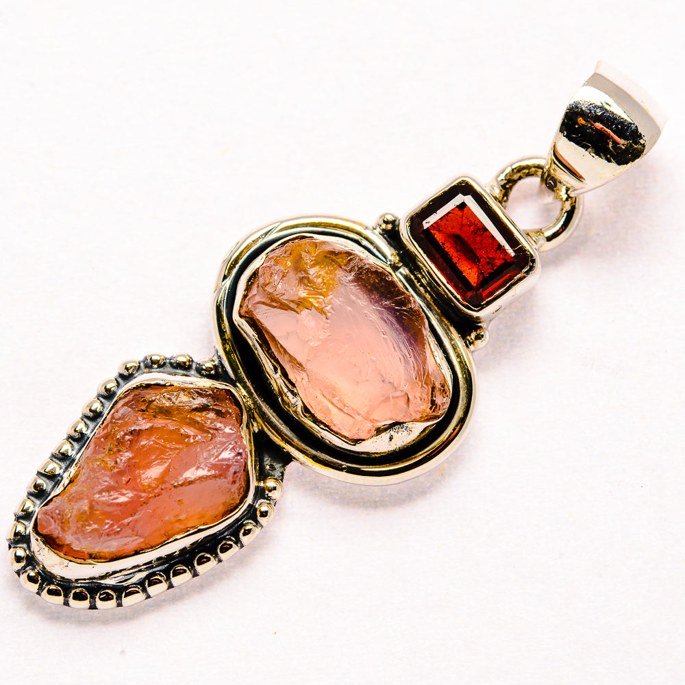 Sterling silver pendant with two rough rose quartz stones, red garnet square, top loop