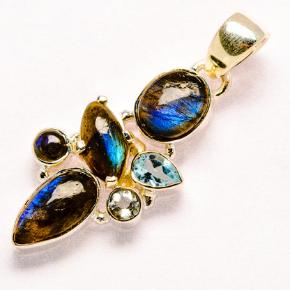 Sterling silver labradorite pendant with blue topaz accents and oval gemstone settings