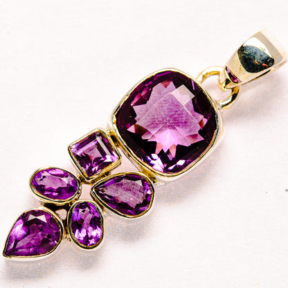Sterling silver faceted amethyst pendant with large oval amethyst and four small stones