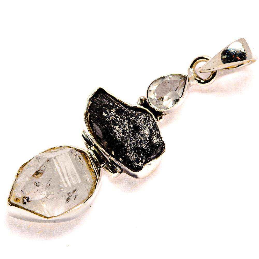Sterling silver pendant with black tektite, faceted clear quartz, and small round crystal