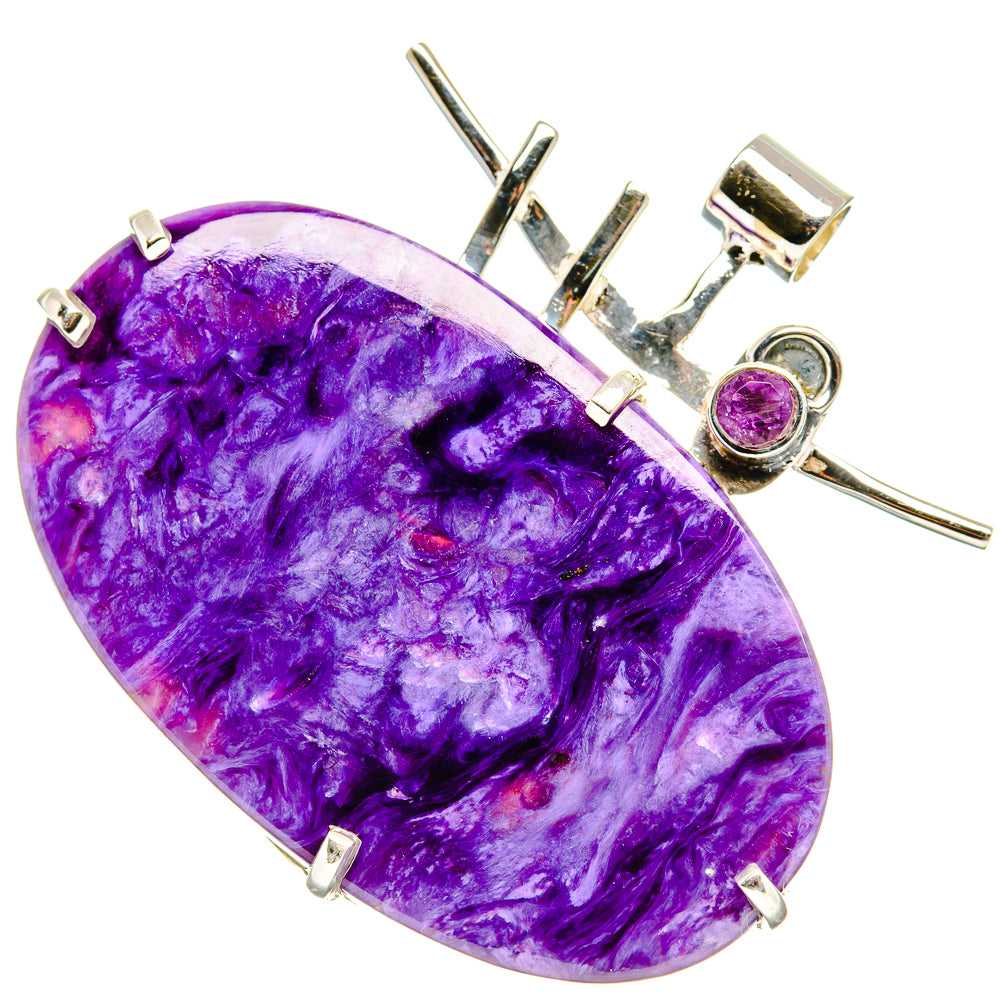 Large oval purple gemstone pendant in silver-tone frame with prongs and round purple stone