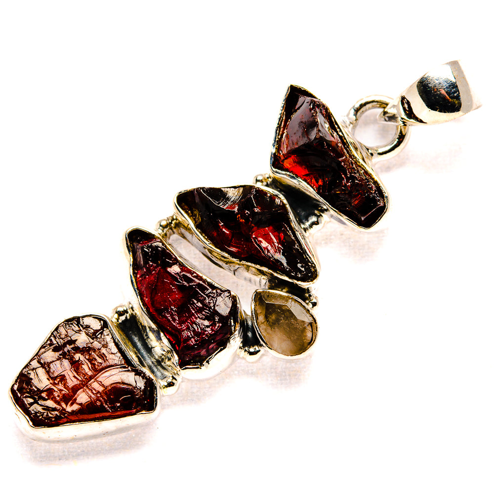 Rough dark red gemstone pendant with silver links and circular bail, clustered stones