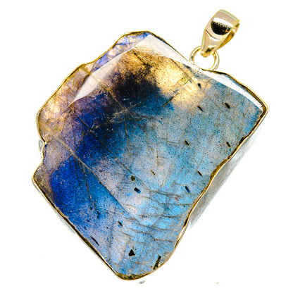 Rough labradorite pendant with gold-tone bail, blue stone in irregular silver frame