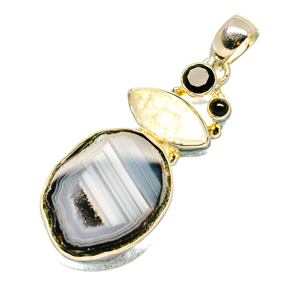 Gold-tone gemstone pendant with oval agate slice, black round stones, and iridescent oval