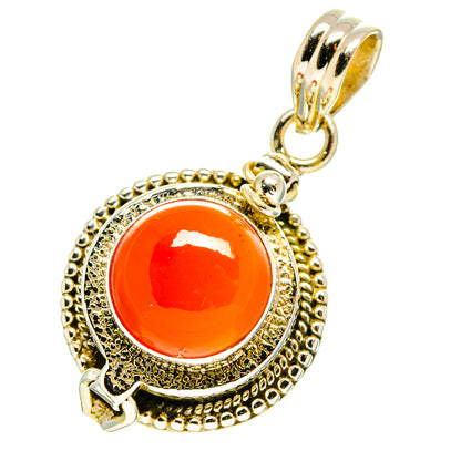Ornate carnelian pendant with orange round stone in textured silver frame, bail