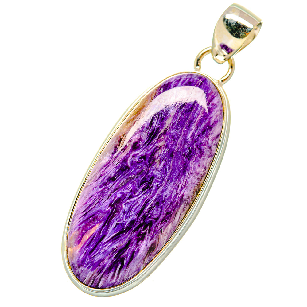 Charoite pendant with oval purple stone bezel, silver tone bail and loop.