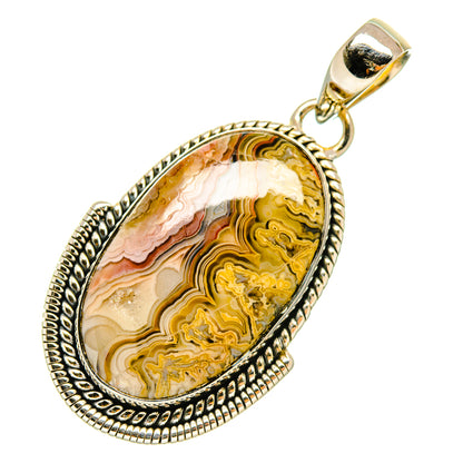 Teardrop lace agate pendant with silver bezel and bail; ornate edge, yellow and cream stone