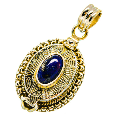 Gold-tone lapis lazuli pendant with oval stone, filigree rim, and top loop