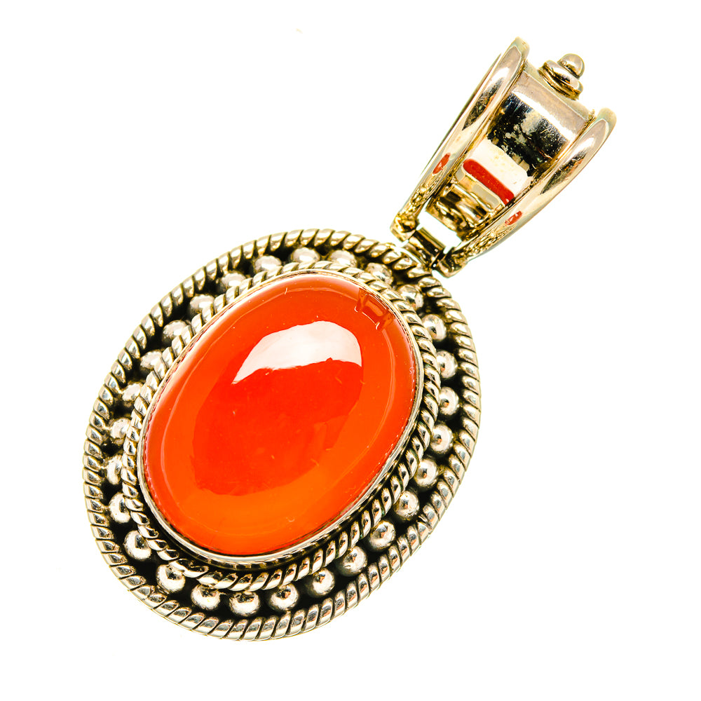 Oval red onyx pendant with braided sterling silver frame and polished bail