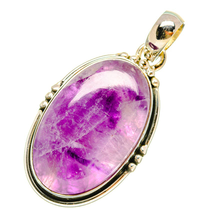 Oval amethyst cabochon pendant in oval sterling silver bezel with bail
