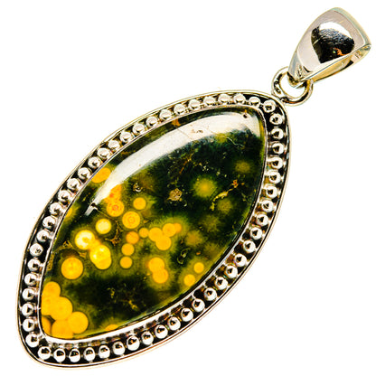 Oval gemstone pendant with bail, green stone and yellow speckled pattern, silver frame
