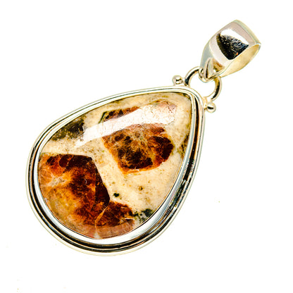 Muscovite teardrop pendant with marbled orange-brown stone in silver frame
