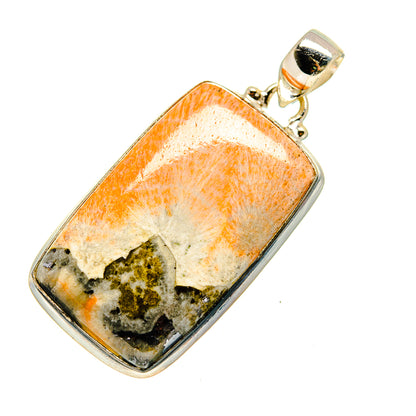 Scolecite pendant with silver bail; orange-cream stone with dark greenish inclusions