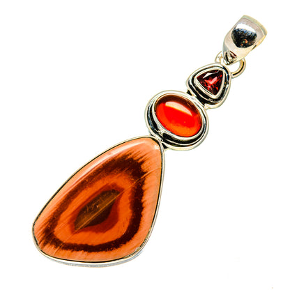 Long teardrop pendant with silver bezel, featuring red cabochons and amber gemstone