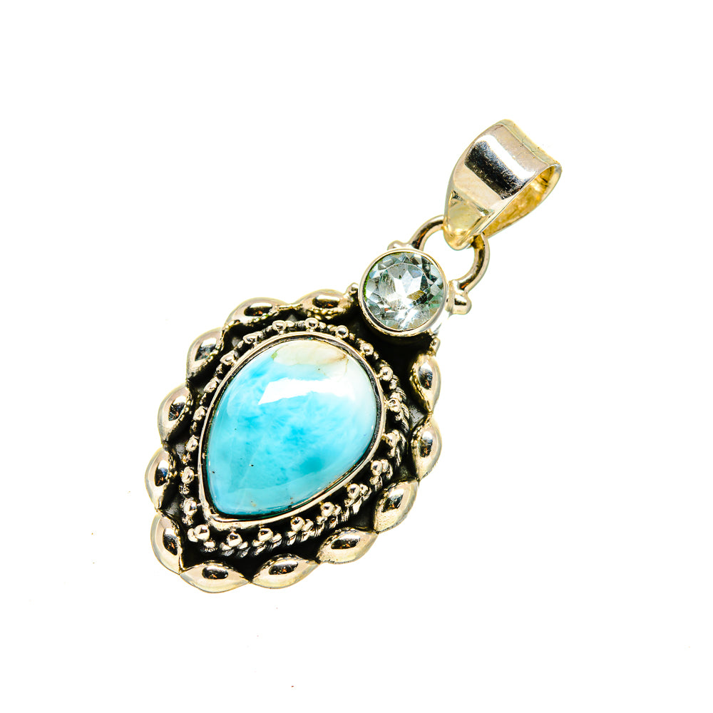 Blue gemstone pendant with ornate bezel, small round clear stone, and top loop bail