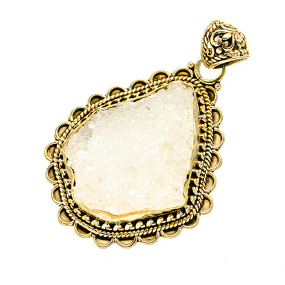 Rough moonstone pendant with ornate gold-tone frame, scalloped border and bail