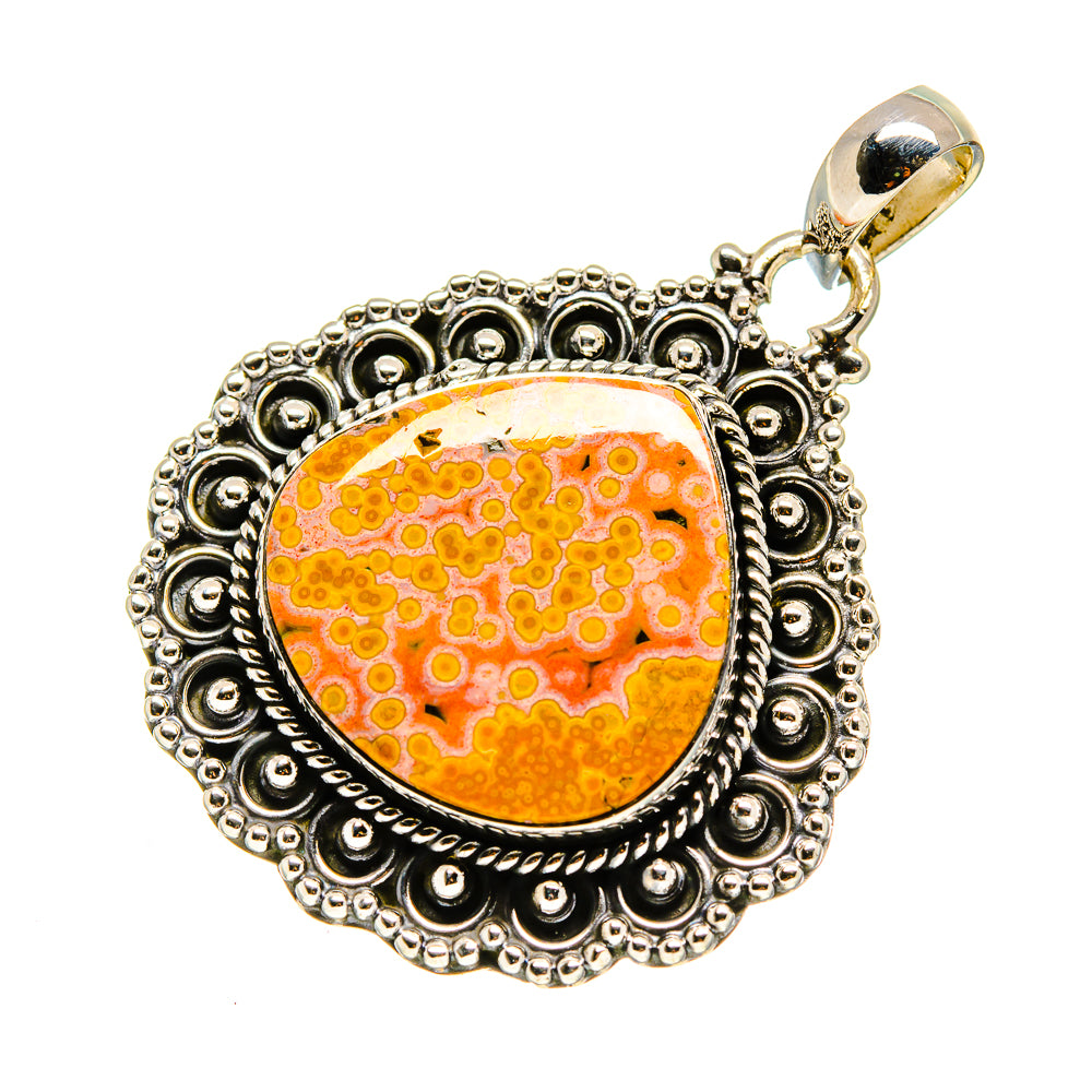 Oval ocean jasper pendant with orange-yellow gem in ornate sterling silver bezel