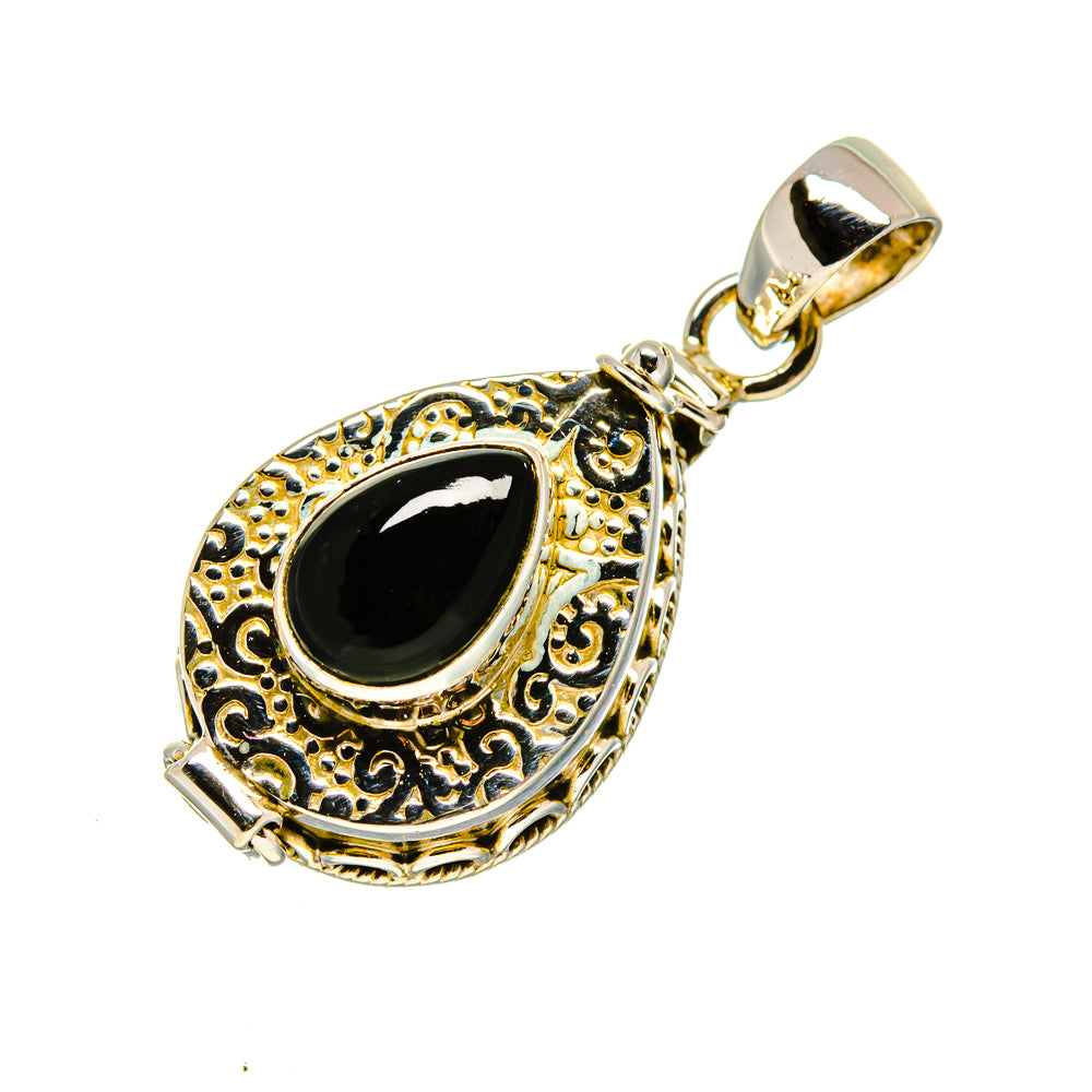 Black onyx teardrop pendant in ornate gold-tone bezel, sterling silver bail